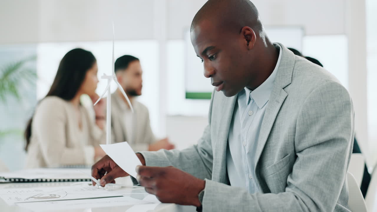Wind turbine, planning and black man in office