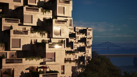 modern concrete apartment building with balconies and a view of a bridge