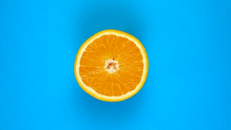 rotation of a juicy orange isolated on blue. 360 degree rotation. sliced orange tree fruit.