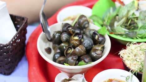 stirring and serving clams with various fresh greens