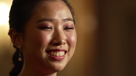 a gracious young woman with radiant smile and elegance, captured in close-up frames showcasing her joyful expression and refined beauty