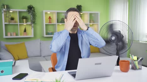 home office worker who is overwhelmed by the heat.