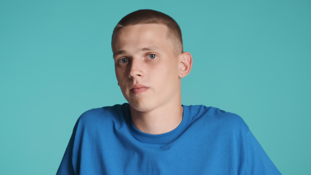 Young man doing shh to the camera