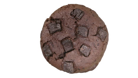 round chocolate fudge cookie spinning, close-up top view, white background