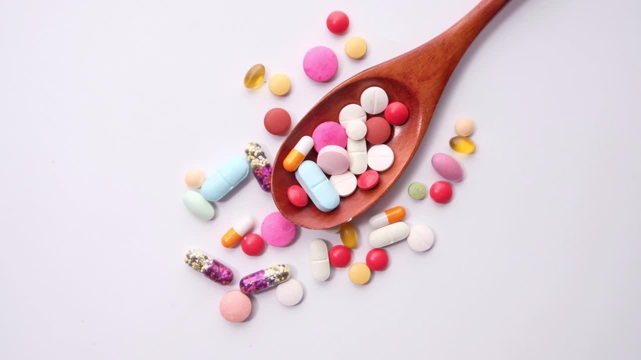 Assorted Medications on Wooden Spoon