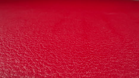 crimson color cow leather material as background macro view