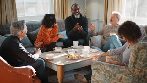 group of middle aged friends meeting around table in coffee shop