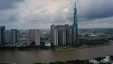 Aerial-view-of-Central-Park-and-Landmark-skyscraper-on-the-Saigon-River-in-Ho-Chi-Minh-City,-Vietnam-in-cloudy-and-rainy-weather