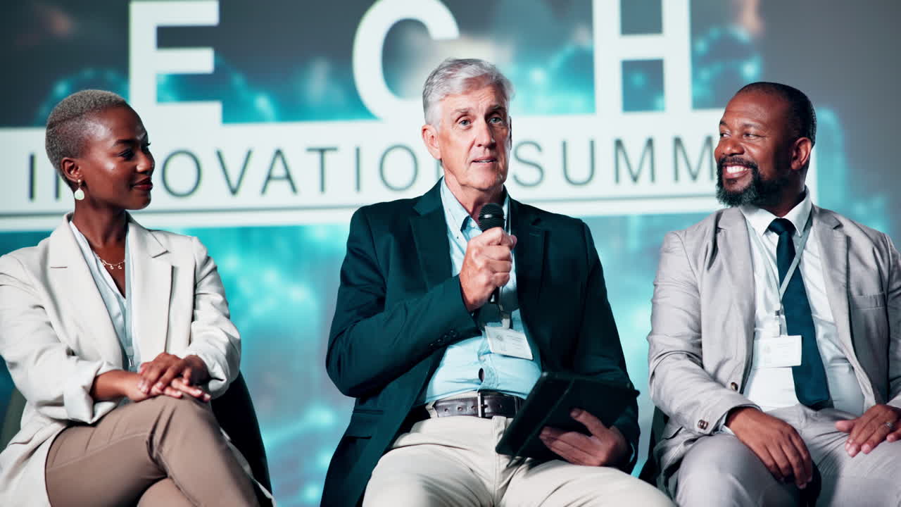 Diverse Panel of Business Speakers Discussing at a Tech Innovation Summit
