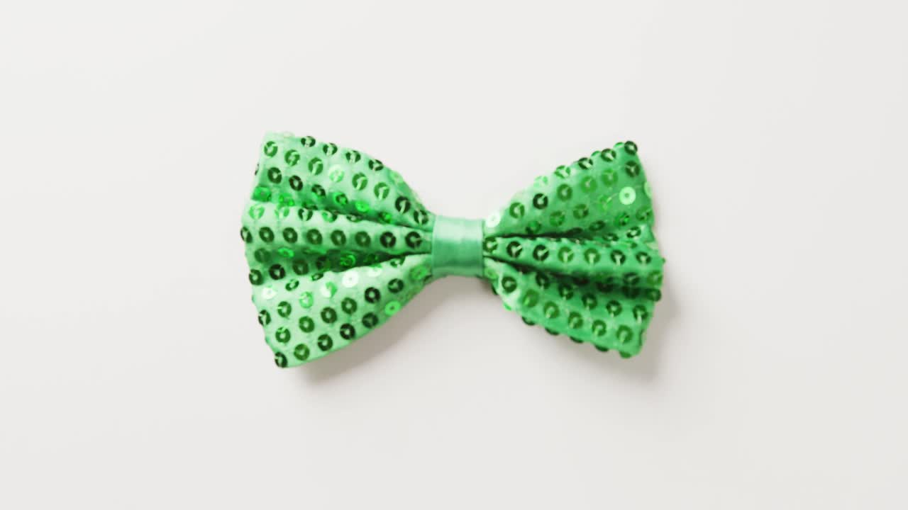 Video of st patrick's green bow tie with copy space on white background