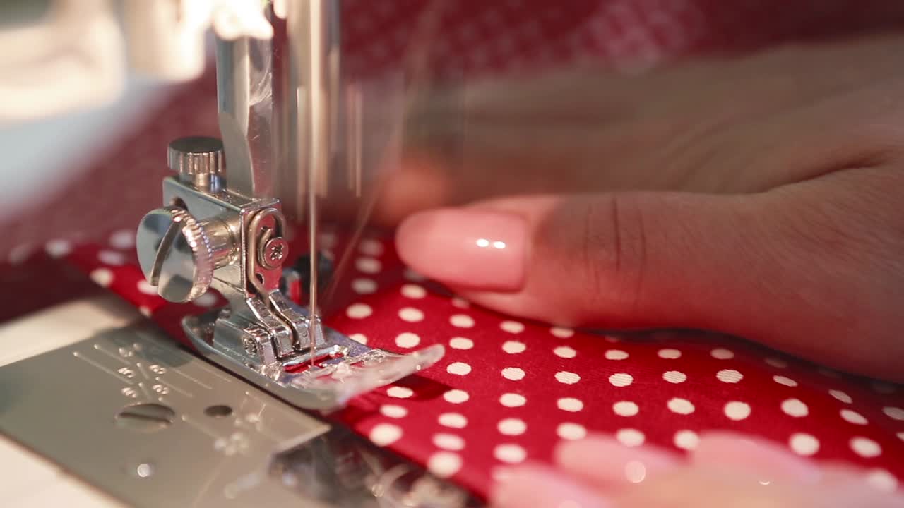 Seamstress at the Table. Close up of sewing machine working part with cloth