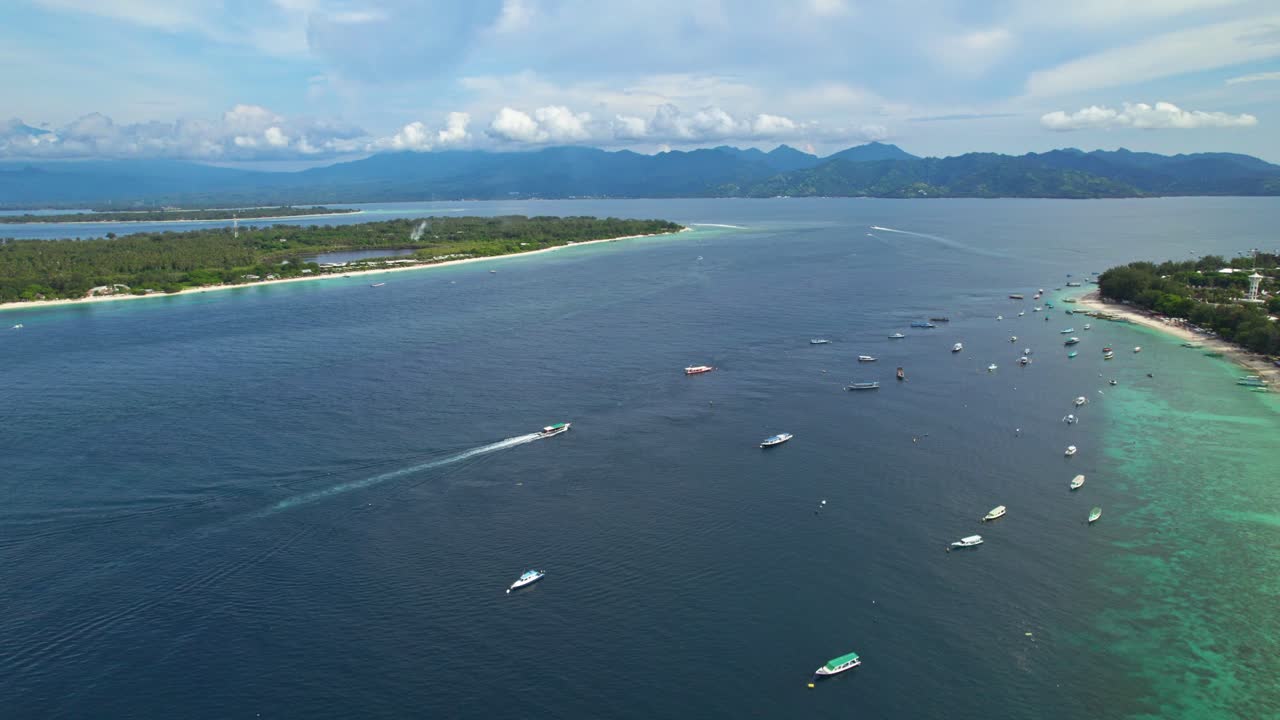 Aerial tracking tourist boat cruising between two tropical islands