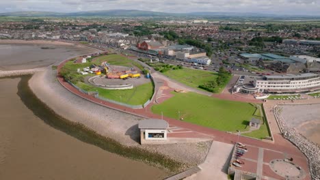 morecambe central promenade and proposed site for the eden project with view to distant mountains. summer. marine road central, morecambe, lancashire, uk