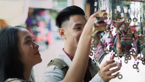 Handheld-view-of-tourists-buying-decorations-at-the-Vietnamese-market