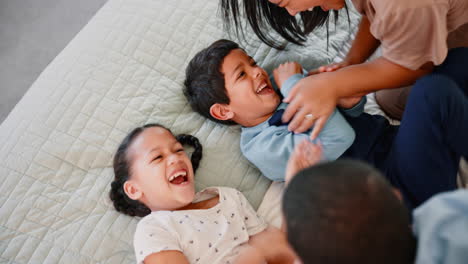 happy family playing on bed