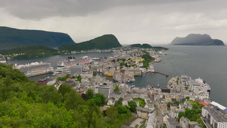 aalesund tourist town with docked cruise ships on geirangerfjord, norway