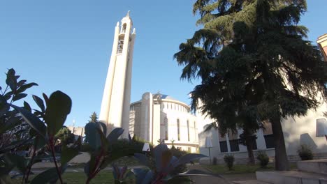 View-to-the-bell-tower-and-dome-of-Resurrection-Cathedral-in-Tirana,-Albania---Wide-push-in-shot-reveal