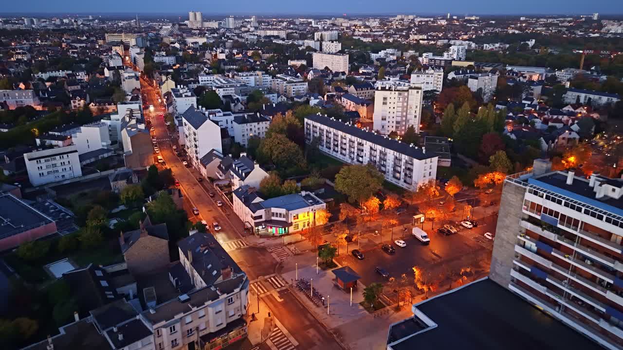 Panorama drone fly over Maurepas district city streets and local buildings at sunset in late evening light, Rennes, Brittany, France