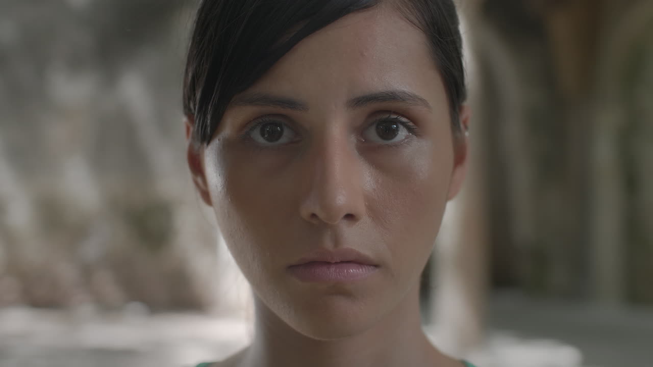 High-quality 4K footage of a serene young woman with closed eyes, then slowly opening them to look forward. Shot in natural, soft light. Ideal for meditation, mindfulness, focus, awakening