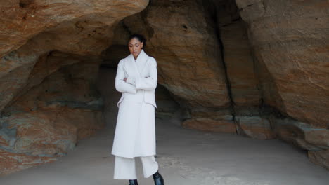 worried african american walking seashore cave. lonely calm woman contemplating