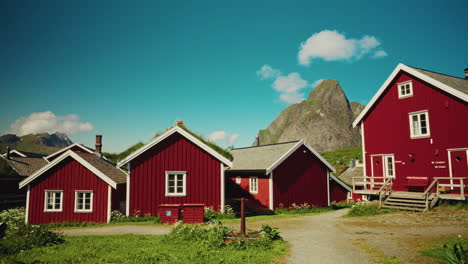 panoramic view of the red wooden fishermen cabins in the lofoten islands, norway. view of the picturesque landscape in the background