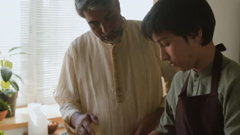 father and son cooking together: passing down family recipes