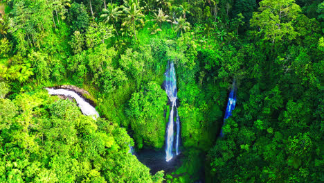 fiji waterfalls cascading down to lagoon in lush rainforest in bali