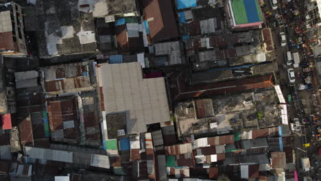 top down aerial urban slum, busy street - city building : establishing drone flight shot