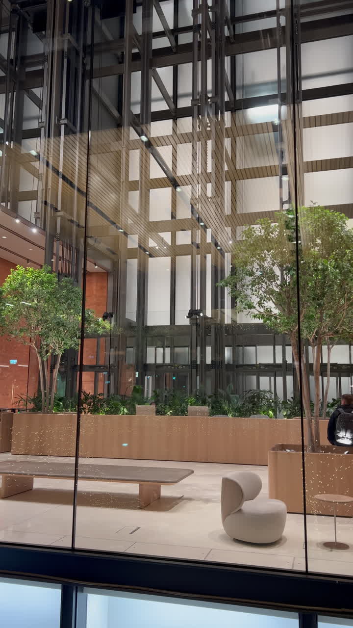 Elevators moving up and down in the Battersea Power Station Mall in London, England. Vertical