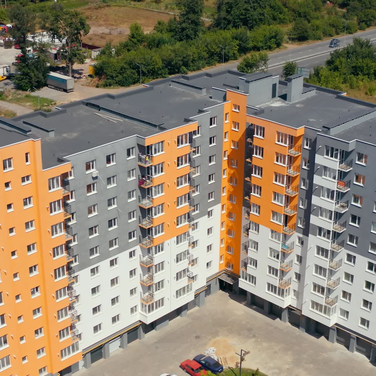 Block of flats in the city. Construction of a new apartment building. Modern high-raised building with colorful walls of residential complex