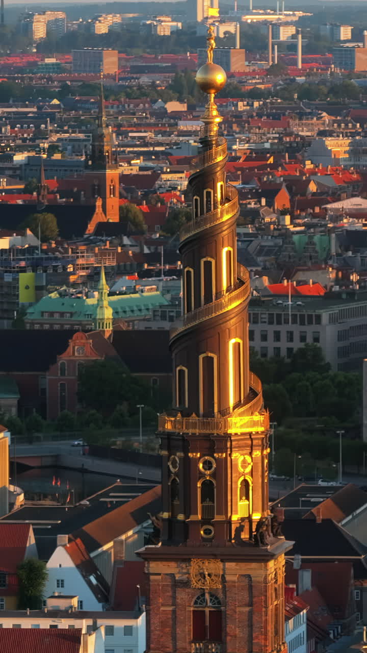 Aerial drone view of the Church of Our Saviour in the city centre of Copenhagen, Denmark at sunset. Vertical