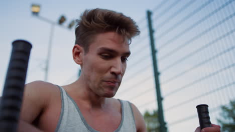 exhausted sportsman training alone in playground. guy doing sport exercise