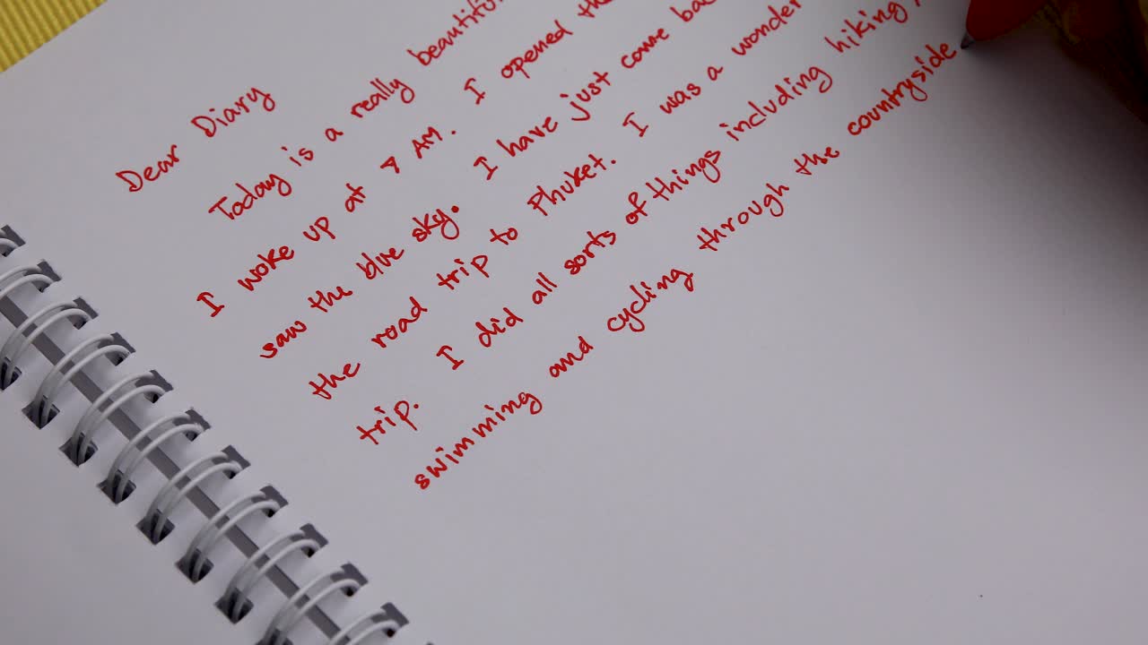 Handwriting a Diary with a Red Pen Overhead Shot Close Up of Woman's Hand