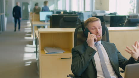 manager talking on phone at office desk