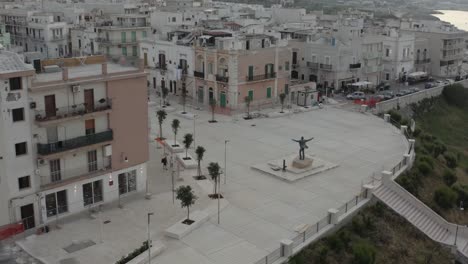 Aerial-circle-view-with-descending-orbit-on-the-coast-with-statue-of-Domenico-Modugno