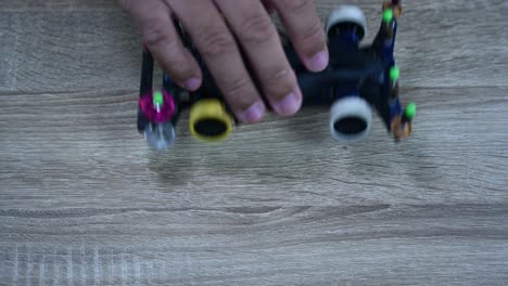 dropping and checking the alignment and balance of a tamiya mini 4x4 wheels in a shop in bangkok, thailand