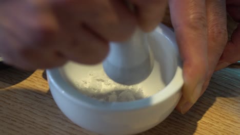 hand grinding salt in mortar with pestle in a korean restaurant