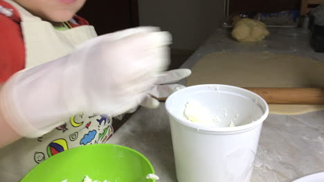 Close-Up-Shot-Of-A-Kid-Crushing-Feta-Cheese-In-A-Bowl