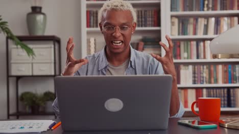 annoyed dark skinned business man upset about problems with laptop