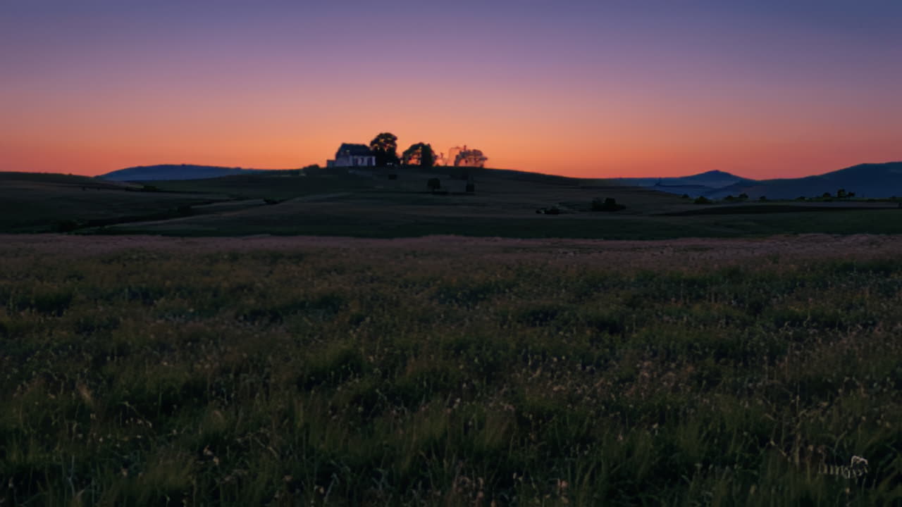 Sunrise over a pastoral landscape with a church