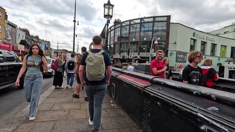 man walking through busy camden town market