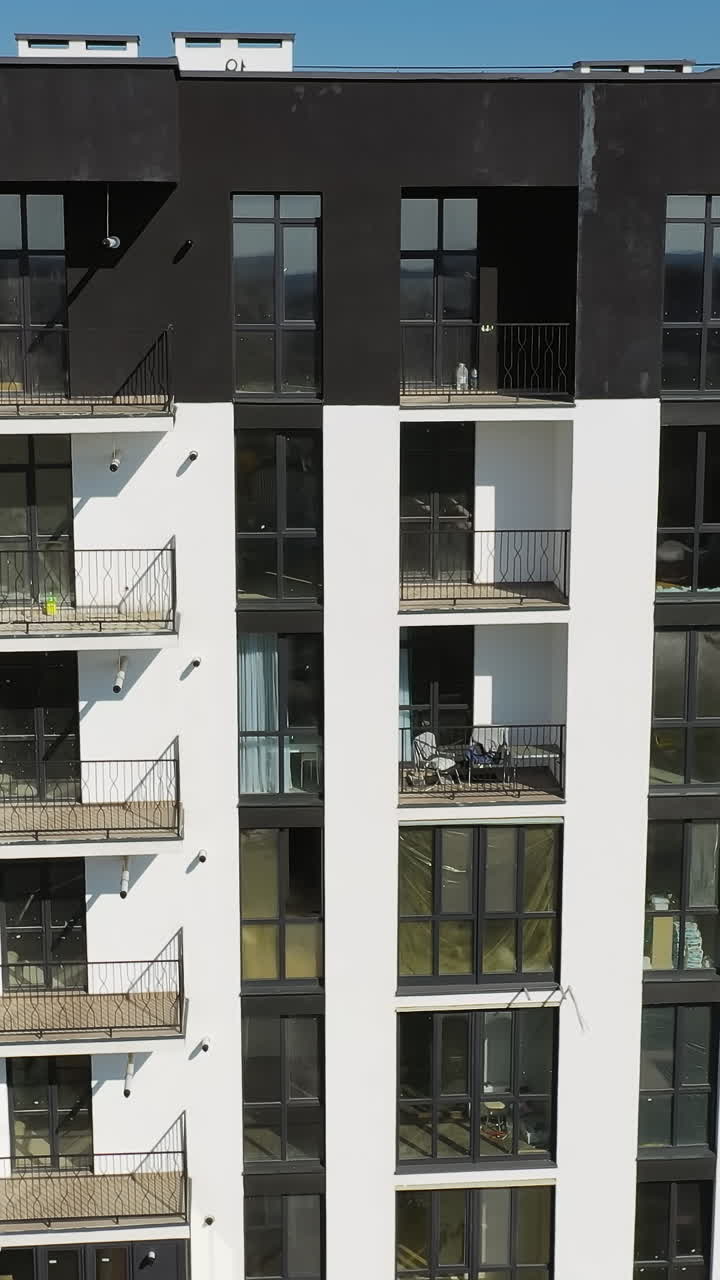 Drone view of new building townhouses. Modern residental apartments exterior. Vertical video