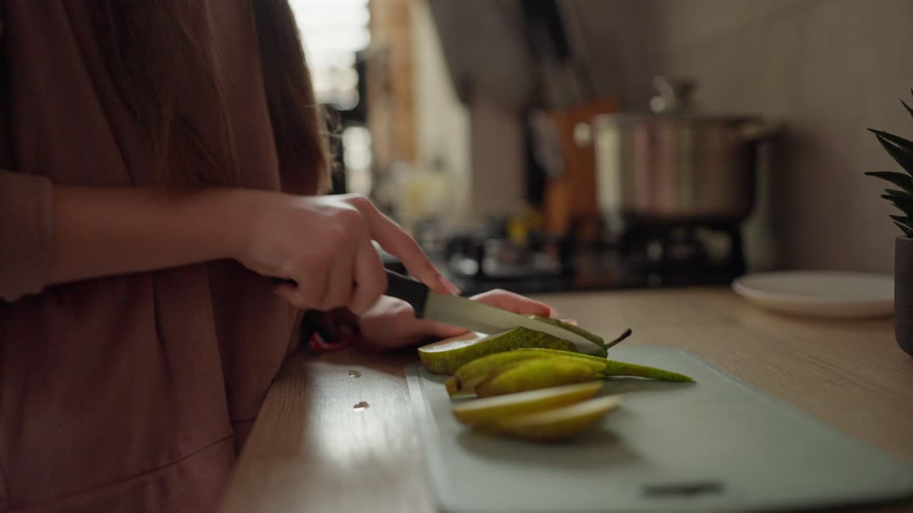 Slicing a Pear in the Kitchen