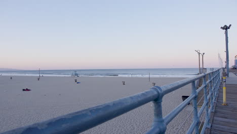 Handheld-shot-of-Santa-Monica-Beach-from-the-pier-at-sunset