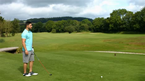 focused man playing golf