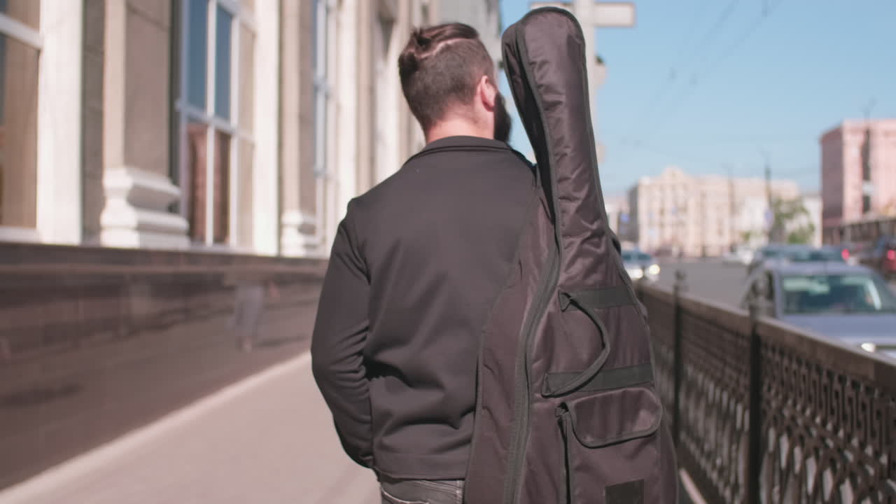 Rear View of Musician Walking in City