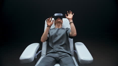 haptic sensors hands man sitting armchair zoom out. person exploring cyberspace