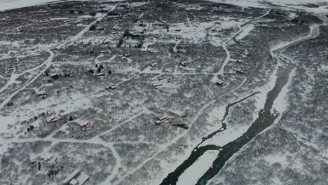 A-beautiful-bird-eye-view-drone-shot-of-the-river-covered-in-ice-around-it-in-Iceland