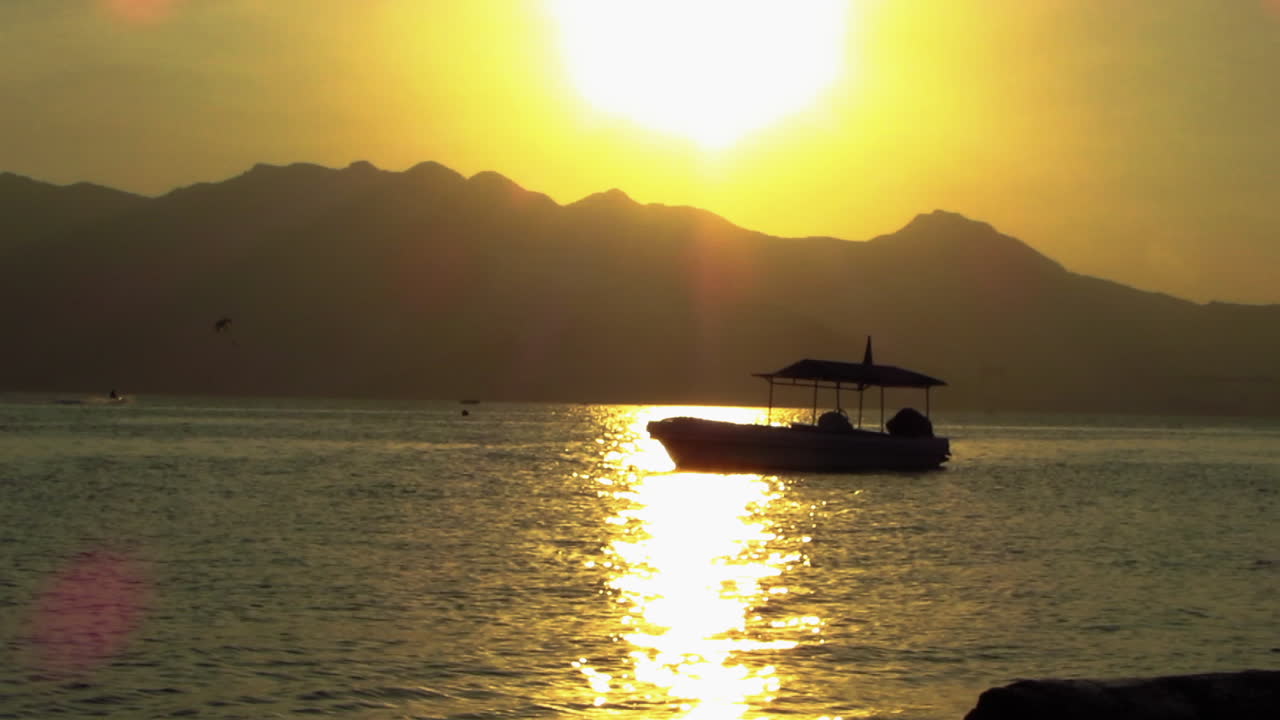 Captivating Sunset View of Subic Bay,  Philippines with Boats and Jet Ski in the Background