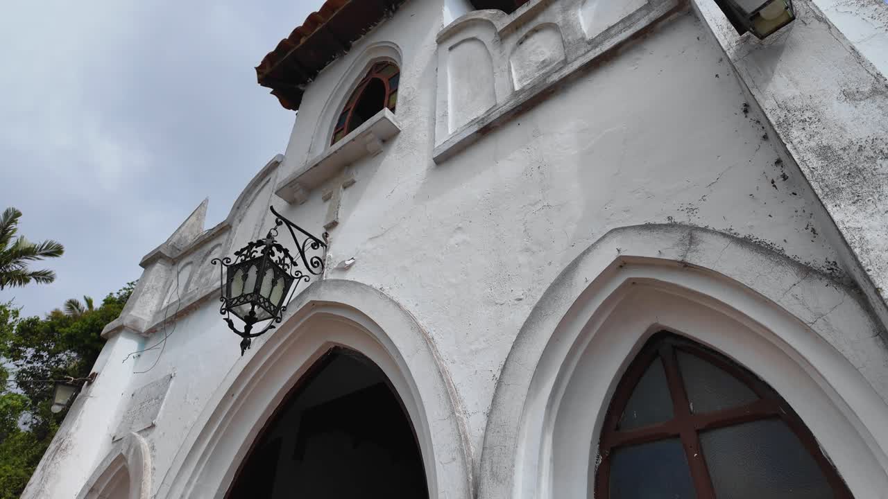 Antique wrought iron Lantern Lamp Adorns Historic Church Facade, Timeless Beauty